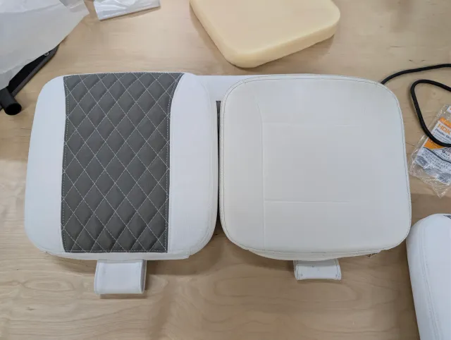 A new quilted cushion beside an old white one, both with strap tabs.