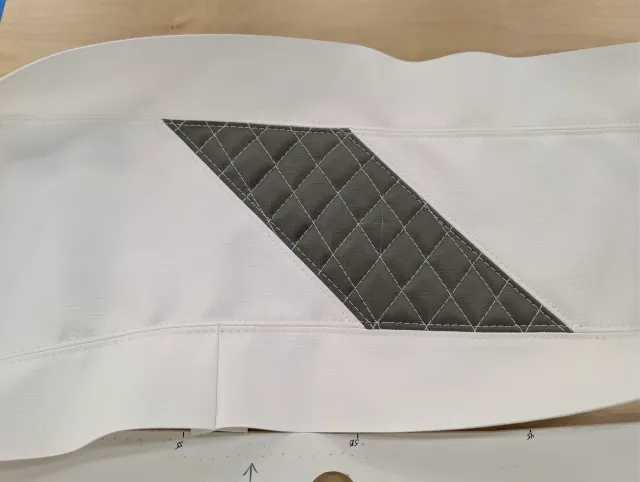 A white boxing strip with a diagonal charcoal quilted panel sewn in.