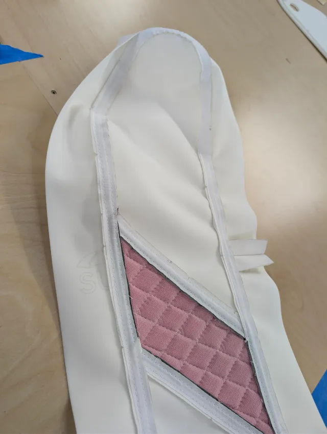 Inside of a cover with taped seams and pink quilted backing in its diagonal panel.