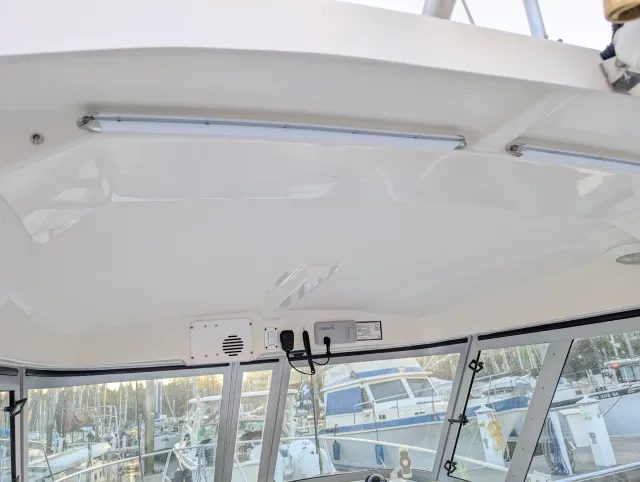 The underside of the hardtop with white track mounted along the overhead and stainless end caps.