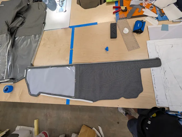 A long charcoal curtain section on the bench, clear window at one end and a zipper along the top.
