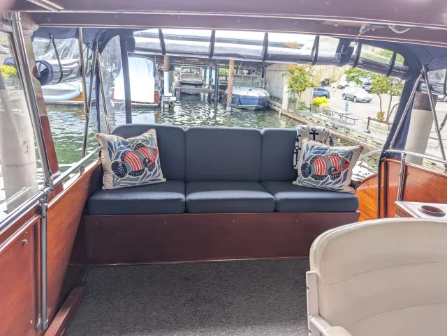 The flybridge aft settee with its six new cushions in Sunbrella Upholstery Heritage Indigo.