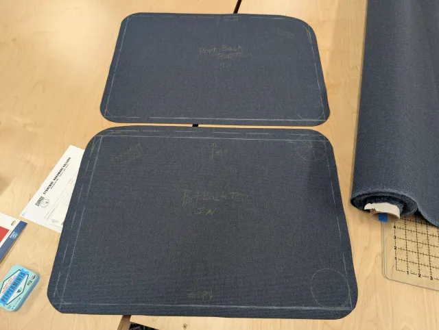 Two back-cushion panels chalked out on navy fabric, one marked Port Back.