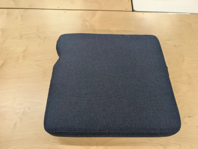 A finished seat cushion from above, one corner notched to clear the bimini corner post.