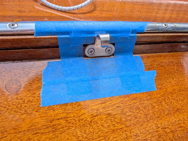 A new stainless hook plate mounted on the rail, shock cord above it.